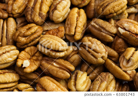Pecan nuts background. Closeup pekan seeds 63801743
