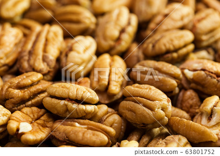 Pecan nuts background. Closeup pekan seeds 63801752