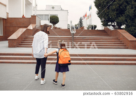 Mother prepare little daughter to school 63802916