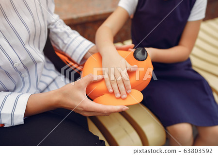 Mother prepare little daughter to school 63803592
