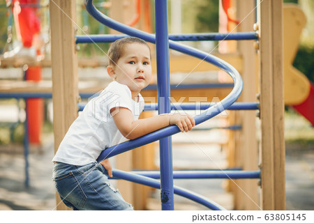 Cute little boy have fun on a playground Cute little boy have fun on a playground 63805145