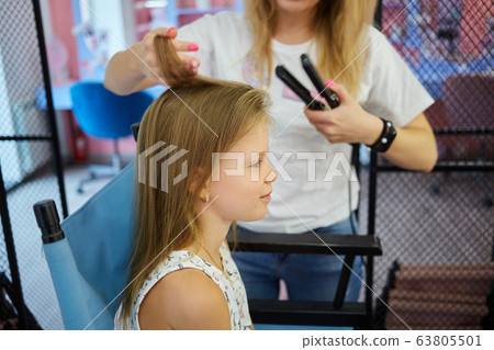 Hairdressing services. Reating hairstyle. Hair styling process. Children hairdressing salon Hairdressing services. Reating hairstyle. Hair styling process. Children hairdressing salon 63805501