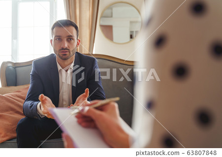 Gesticulating man telling about his psychological problems Gesticulating man telling about his psychological problems 63807848