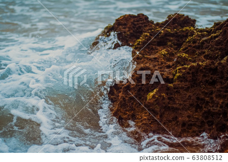 Storm in the ocean, sea waves crashing on rocks on the beach coast, nature and waterscape Storm in the ocean, sea waves crashing on rocks on the beach coast, nature and waterscape 63808512
