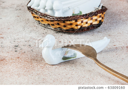 Antique porcelain duck cutlery stand on concrete Antique porcelain duck cutlery stand on concrete 63809160