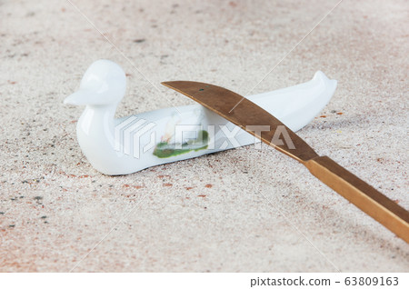 Antique porcelain duck cutlery stand on concrete 63809163