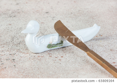 Antique porcelain duck cutlery stand on concrete 63809164