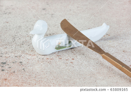 Antique porcelain duck cutlery stand on concrete Antique porcelain duck cutlery stand on concrete 63809165