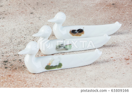 Antique porcelain duck cutlery stand on concrete Antique porcelain duck cutlery stand on concrete 63809166