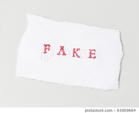 Word Fake  written on torn paper 63809664