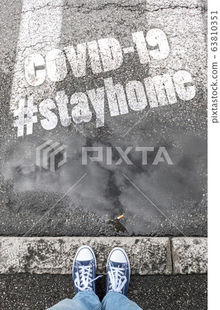 Feet on sidewalk with hashtag STAYHOME Feet on sidewalk with hashtag STAYHOME 63810351