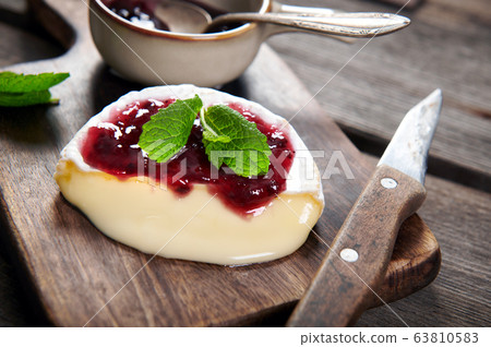 Tasty camembert cheese from the oven served with Tasty camembert cheese from the oven served with 63810583