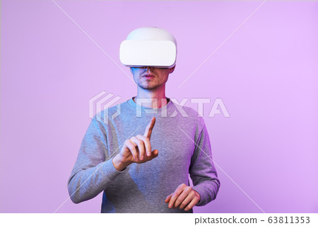 Man is using virtual reality headset. 63811353
