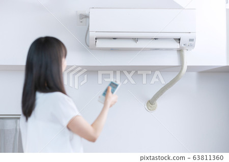 Air conditioner woman white background Air conditioner woman white background 63811360