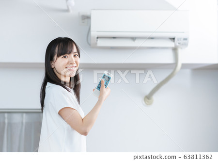 Air conditioner woman white background Air conditioner woman white background 63811362