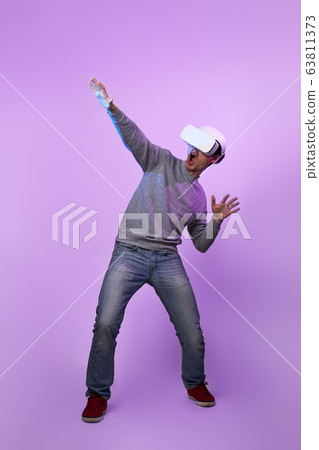 Man is using virtual reality headset. 63811373