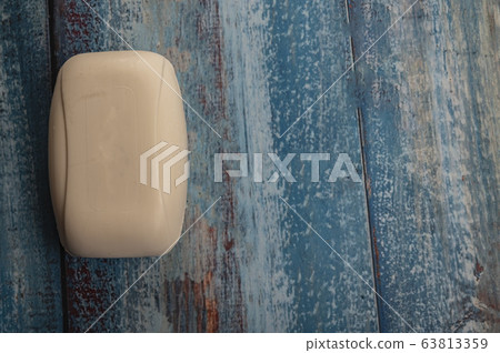 A piece of toilet soap on a wooden background. A piece of toilet soap on a wooden background. 63813359