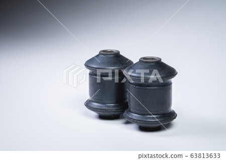 Two silent blocks on a gray background. New car suspension parts Two silent blocks on a gray background. New car suspension parts 63813633