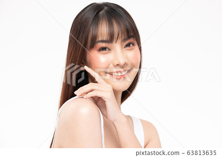 Young Beautiful Asian woman smile touching soft cheek Young Beautiful Asian woman smile touching soft cheek 63813635