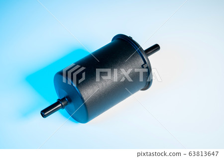 New fuel filter in a black plastic housing for diesel and gasoline engines on a gray background 63813647