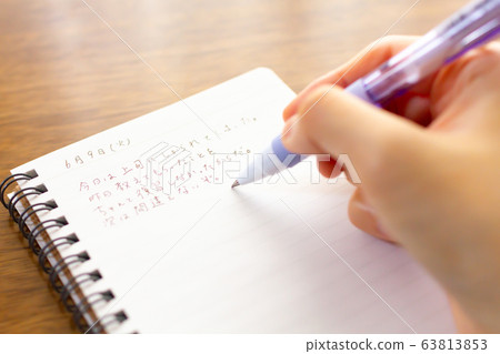 At hand of person writing diary 63813853