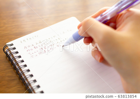 At hand of person writing diary 63813854