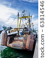 Old rusty fishing ship moored in harbor 63814546