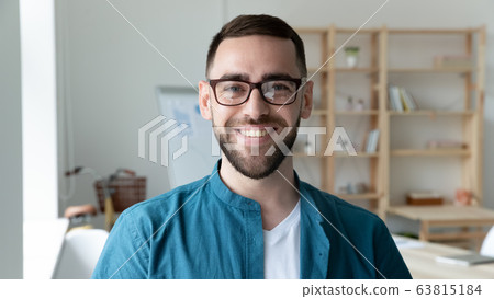 Portrait of smiling male boss posing in modern office 63815184