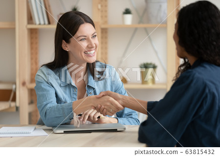 Smiling female employer handshake job candidate at briefing 63815432