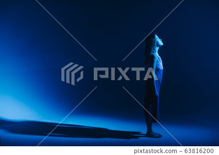 Young stylish girl dancing in the Studio on a colored neon background. Classic dancer. Young stylish girl dancing in the Studio on a colored neon background. Classic dancer. 63816200