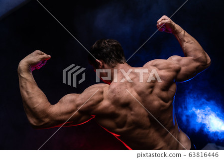 Muscular man showing muscles isolated on the black background.healthy lifestyle Muscular man showing muscles isolated on the black background.healthy lifestyle 63816446