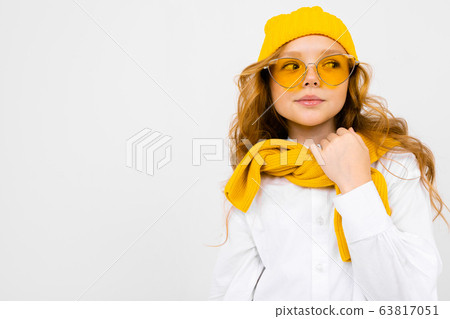 romantic teenager girl with yellow retro glasses and with a yellow hat and scarf on an isolated romantic teenager girl with yellow retro glasses and with a yellow hat and scarf on an isolated 63817051