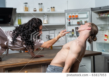 Sexual game between couple on the table in the kitchen. concept of variety of sex life 63817053