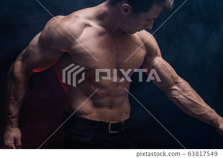 Muscular man showing muscles isolated on the black background.healthy lifestyle  63817549