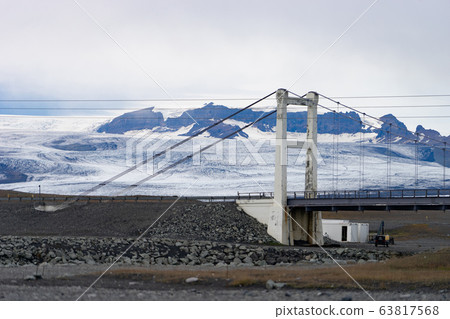 Beautiful cold landscape of Jokulsarlon glacier lagoon, Iceland, during the summer with the bridge as a background 63817568