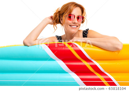 sexy girl with inflatable swimming circles and mattresses on vacation on a white background sexy girl with inflatable swimming circles and mattresses on vacation on a white background 63818104