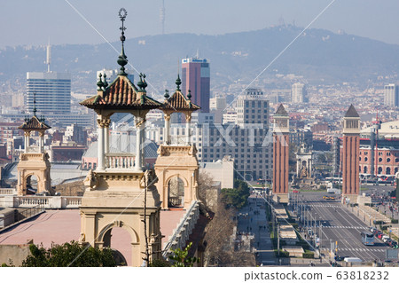 Decorative old buildings of National Palace against panorama of Barcelona. City view from Plaza de Espana in sunny day 63818232