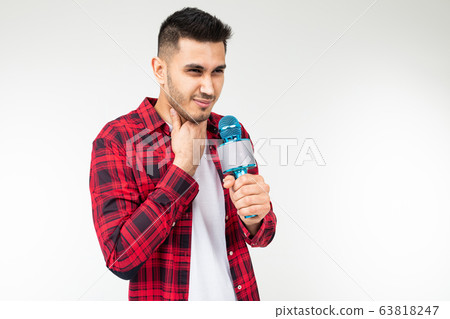 guy sings in karaoke holding a microphone in his hand on a white background 63818247