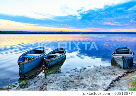 Old blue-green boats moored to the shore Old blue-green boats moored to the shore 63818877