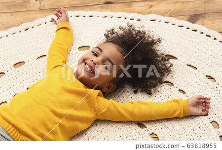 African american little girl on carpet, stay at home African american little girl on carpet, stay at home 63818955