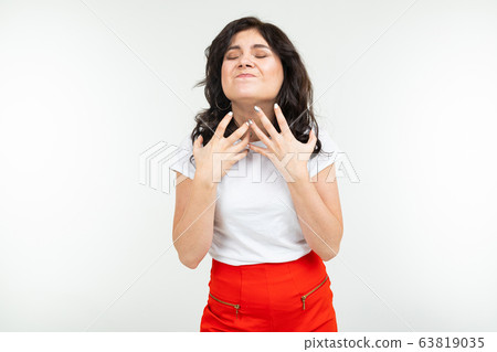disgruntled girl in a white T-shirt is fed up on a white studio background disgruntled girl in a white T-shirt is fed up on a white studio background 63819035