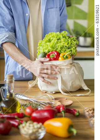 Man vegetarian buying vegetables and want to prepare dinner Man vegetarian buying vegetables and want to prepare dinner 63819621
