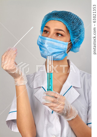 Young female doctor with swab and medical test tube. 63821353