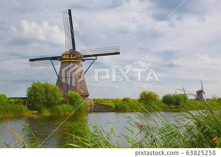 Windmill beside a canal Windmill beside a canal 63825258