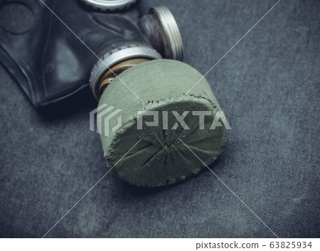 Protective gas mask with a filter on a gray dirty 63825934