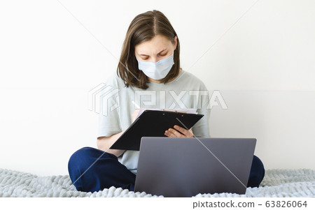 Coronavirus. Quarantine. Girl and distance learning. Studying online. Coronavirus. Quarantine. Girl and distance learning. Studying online. 63826064
