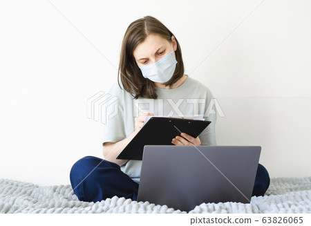 Coronavirus. Quarantine. Girl and distance learning. Studying online. Coronavirus. Quarantine. Girl and distance learning. Studying online. 63826065