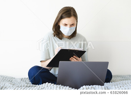 Coronavirus. Quarantine. Girl and distance learning. Studying online. 63826066