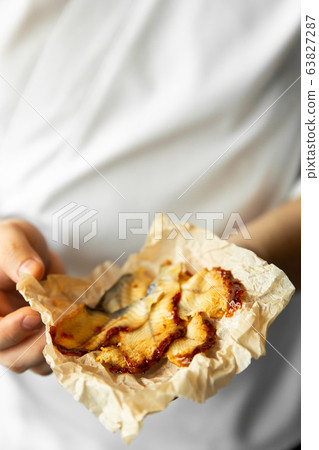 chef holding smoked eel slices in his hands. eel slices in chef hands. chef holding smoked eel slices in his hands. eel slices in chef hands. 63827287