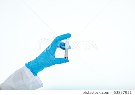 Doctor's hand in a medical glove holds a test tube 63827931